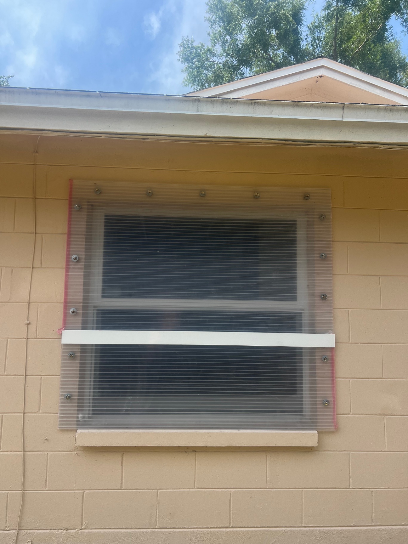 Hurricane shutter installed over front window