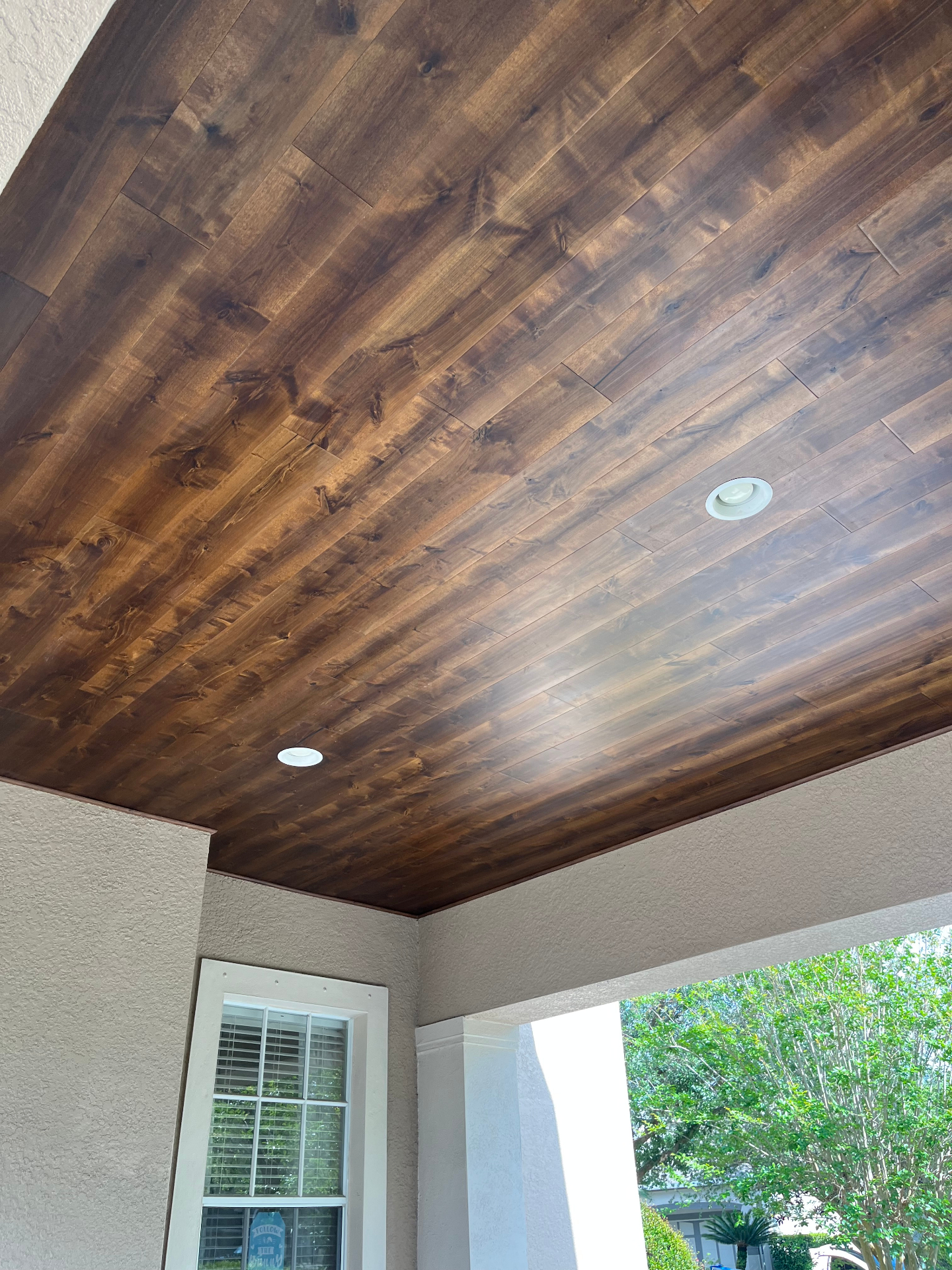 Finished stained wood plank porch ceiling
