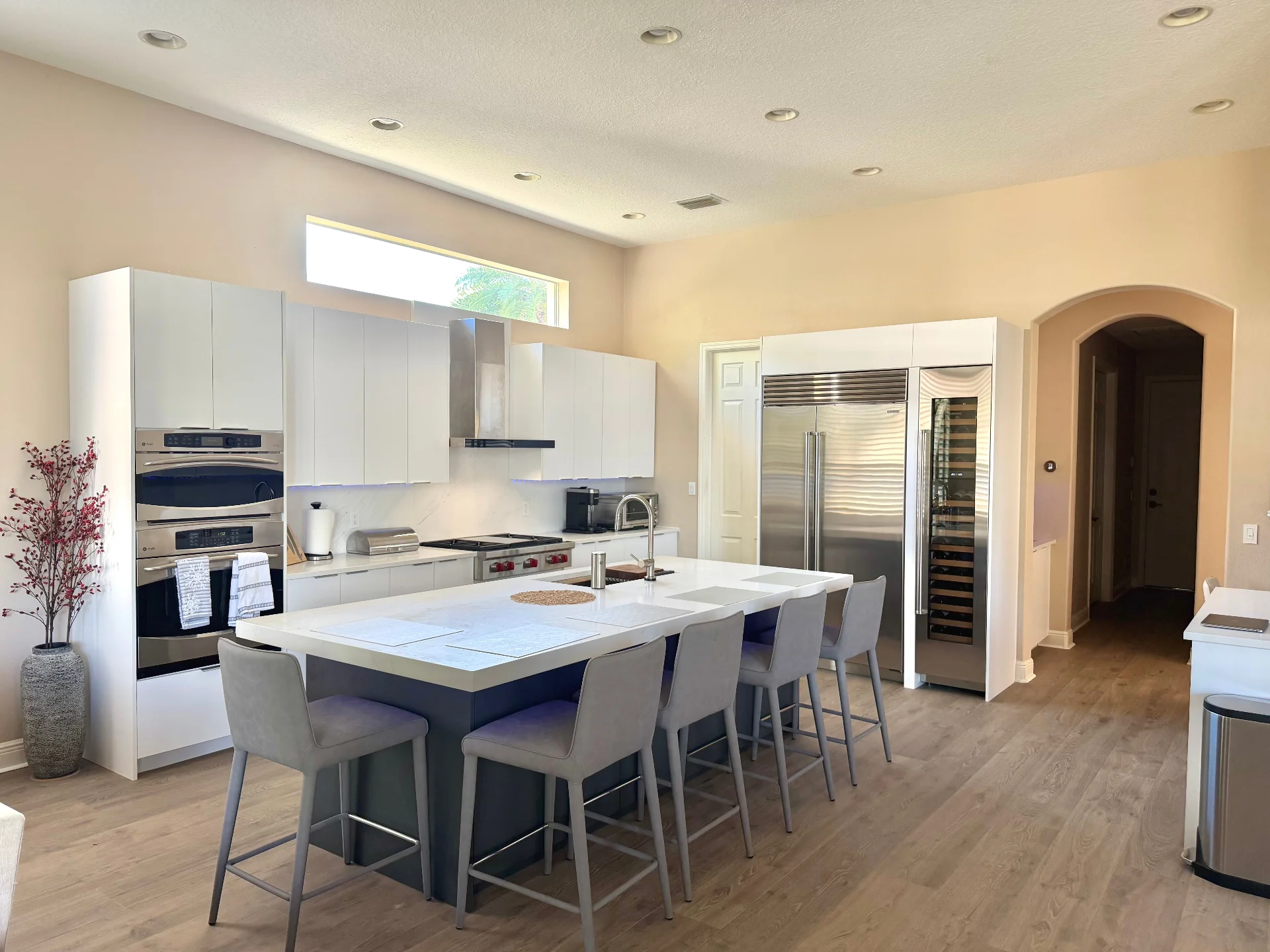 European-style kitchen remodel with custom cabinets, stone counters, and flush-installed appliances
